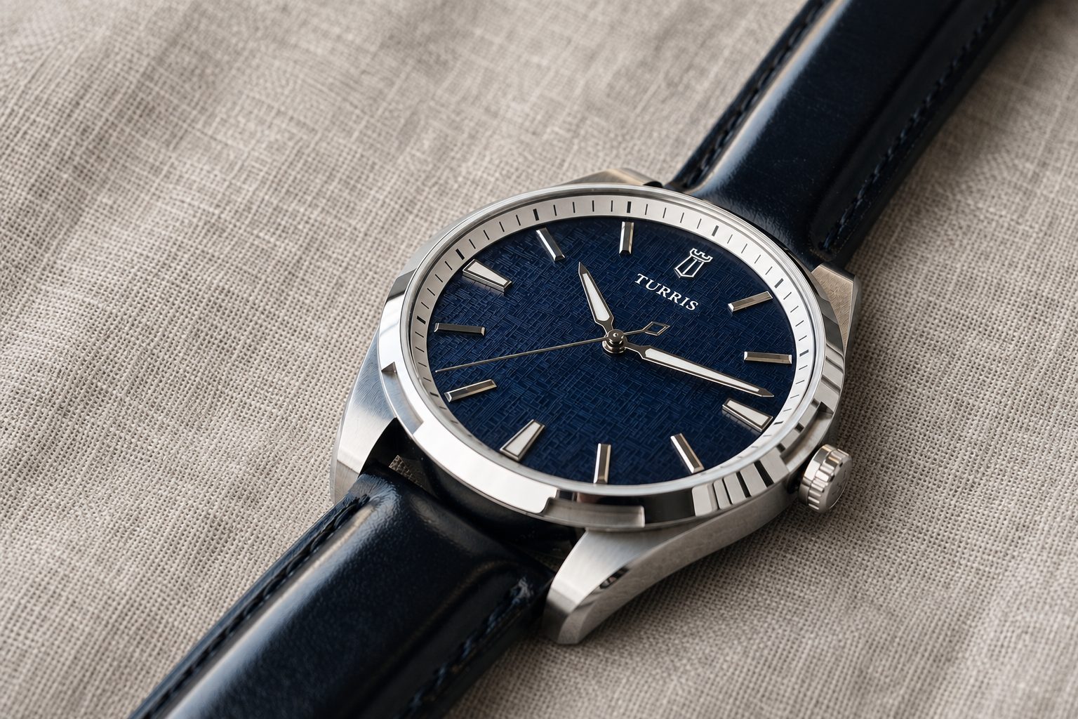 Blue Turris Accord prototype on linen, showing the full case, angled bezel and crown
